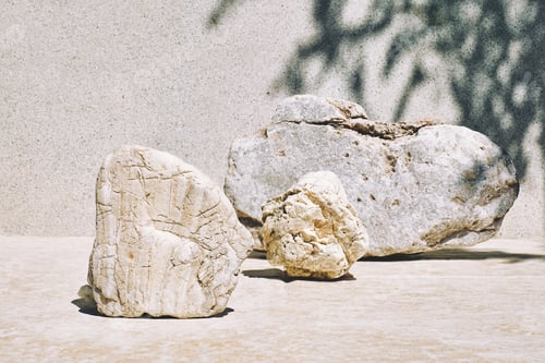 Preview: White stone as podiums display before light pastel surface with shadows for product presentation.