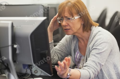 Preview: Angry Mature Student Working With Computer In Computer Class