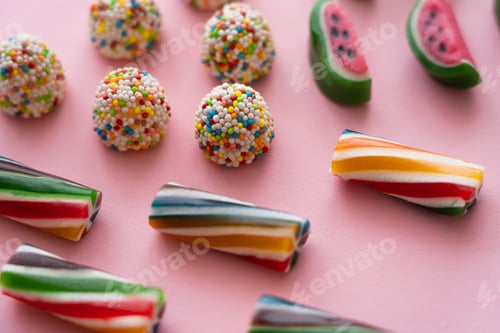 Preview: Close up view of different candies on pink background