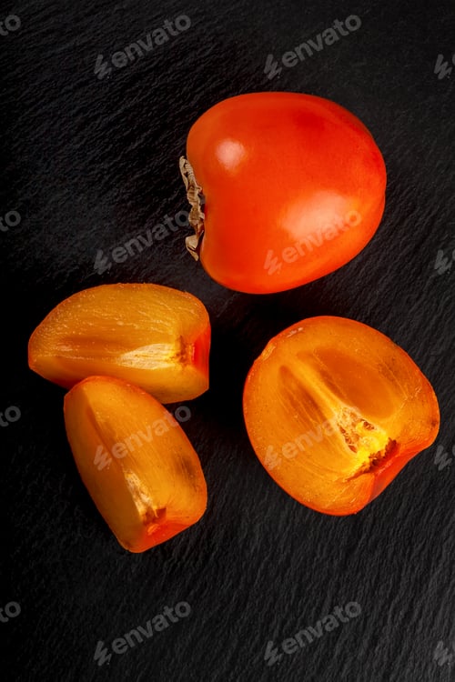 Preview: Sweet ripe persimmons on black background