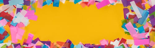 Preview: Panoramic shot of multicolored confetti frame on yellow background