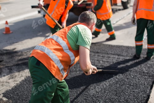 Preview: Workers on Asphalting paver machine during Road street repairing works.