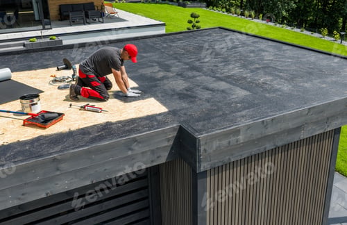 Preview: Worker Installing EPDM Roofing Material on a Residential Flat Roof During a Sunny Day