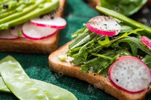 Preview: close up of fresh sandwiches with radish and greens on cloth