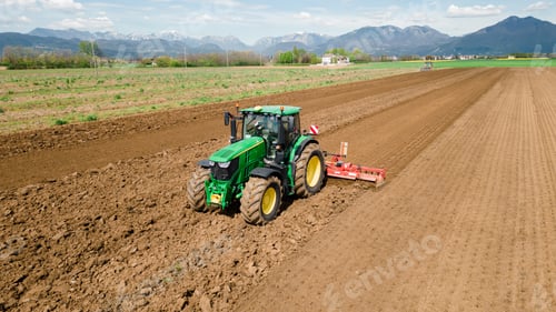 Preview: A picture of a rural farming community showcasing the use of farming machinery and equipment, such