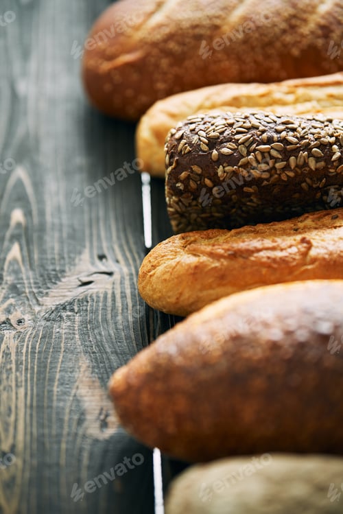 Preview: Various fresh loaves of bread on wooden background