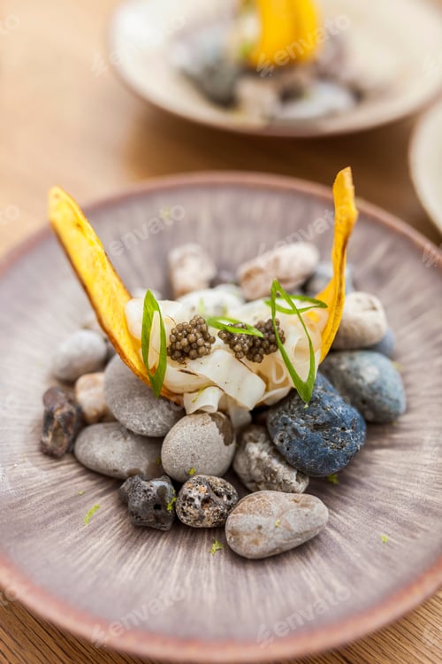 Preview: Banana chifles with fake squid noodles and beluga caviar on wooden table