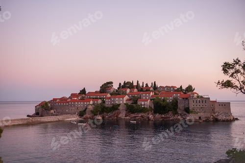 Preview: Panoramic view of Sveti Stefan in Montenegro at pink sunset. Famous tourist place near Budva Natural