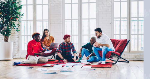 Preview: Diverse group of creative graphic designers discussing ideas while analyzing paperwork in flat