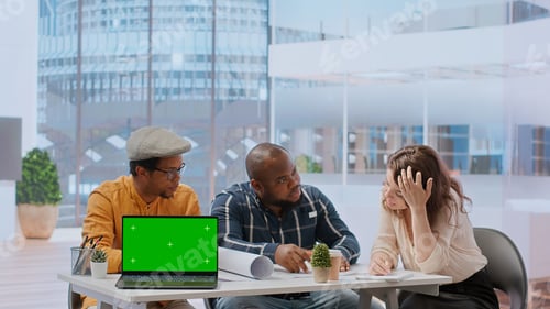 Preview: Diverse people meeting on an office tour next to laptop with green screen