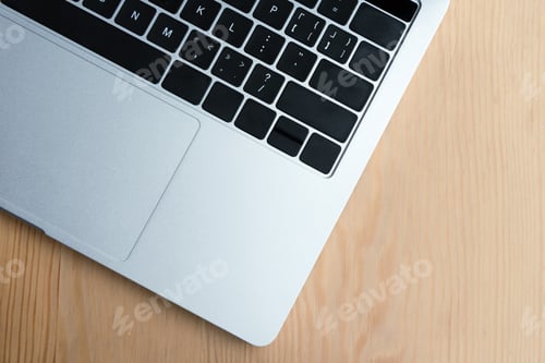 Preview: top view of laptop computer keyboard on wooden table