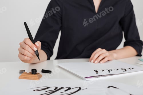 Preview: Beautiful photo of young woman hands writing on paper on desk isolated