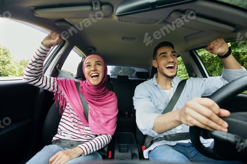 Preview: Road Trip. Excited Happy Muslim Spouses Having Fun While Riding Car Together