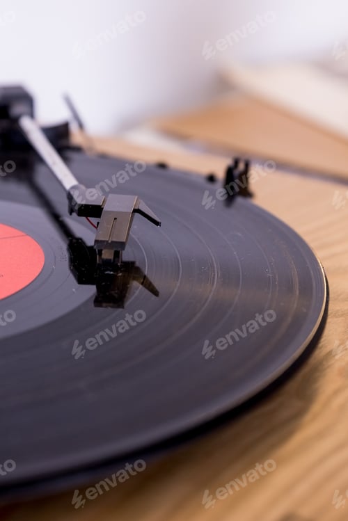 Preview: retro player with vinyl disk on blurred background.Old gramophone turntable with disc.playing vinyl