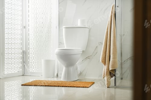 Preview: Toilet bowl near shower stall in modern bathroom interior