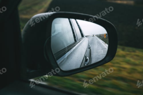 Preview: Driving car along the country road in autumn, view at side wing mirror of the vehicle