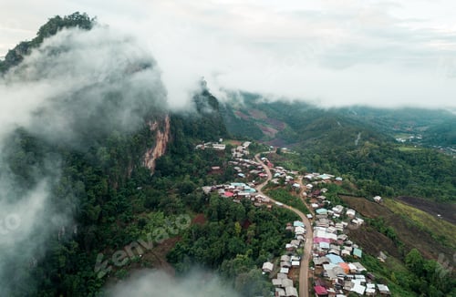 Preview: Top view of countryside road passing through the green forrest and mountain