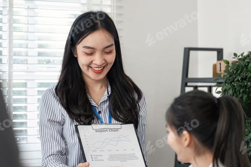 Preview: Business professional sharing a report chart with a colleague in an office setting