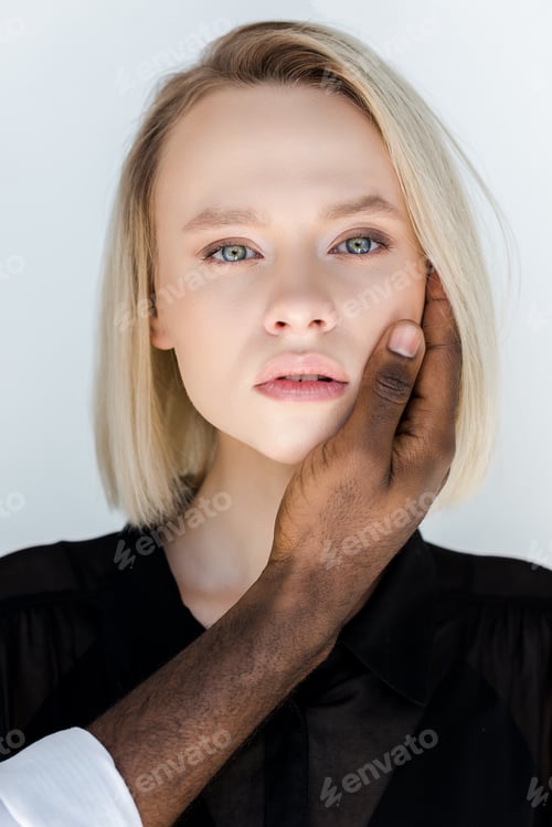 Preview: cropped image of african american boyfriend touching blonde girlfriend face isolated on white