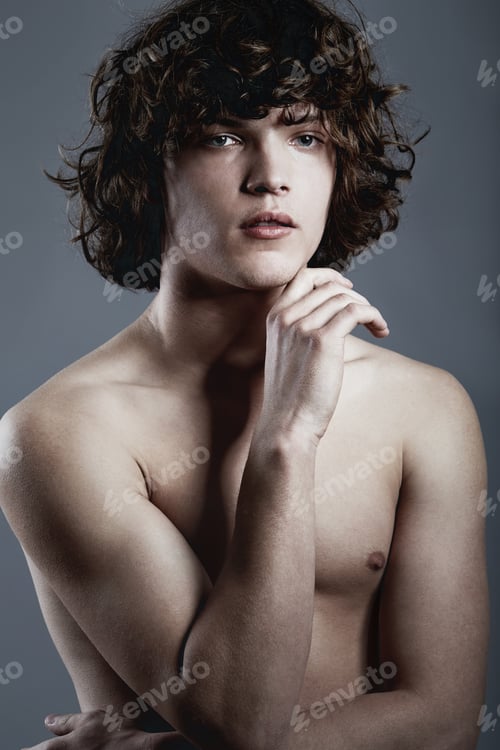 Preview: Cool confidence. Studio shot of a handsome young man posing against a gray background.