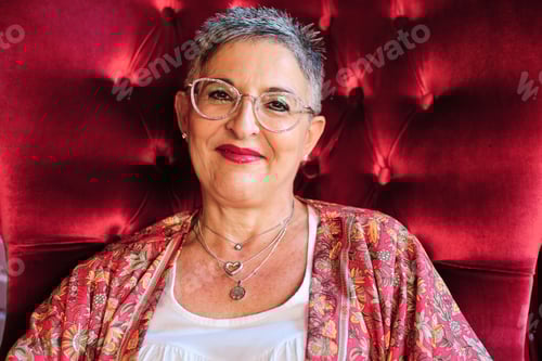 Preview: Stylish Woman Relaxing in Red Velvet Chair
