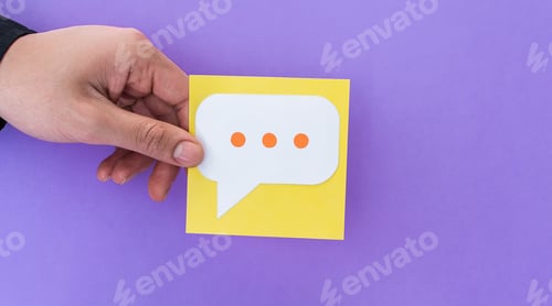 Preview: Closeup of a person holding typing bubble isolated on a purple background