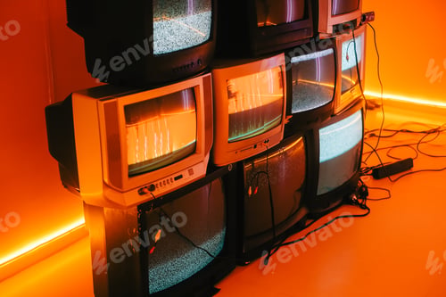 Preview: Old vintage tvs on a floor in a room with colored neon light.