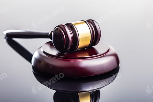Preview: Wooden judge gavel on mirror table.