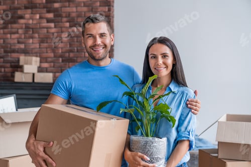 Preview: Cheerful young couple moving in their new home