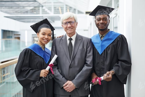 Preview: Students posing with profession at graduation ceremony