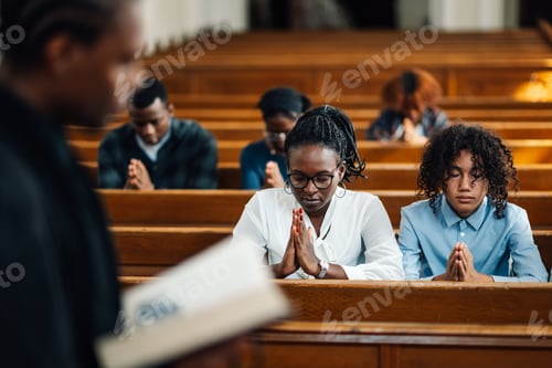 Preview: Congregation praying in church during sermon