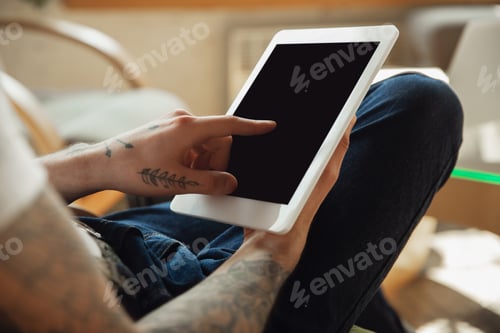 Preview: Close up of male hands using tablet with blank screen, copyspace, education and business concept