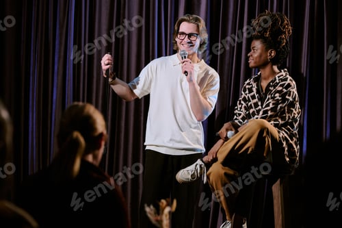 Preview: Comedian Performing Stand-Up Comedy on Stage with Audience