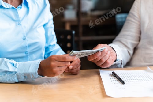 Preview: counting bills in the bank office