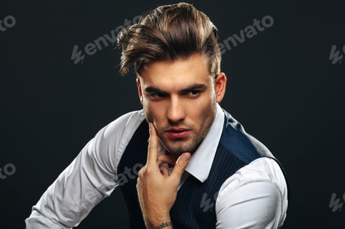 Preview: Portrait od handsome man in studio on dark background