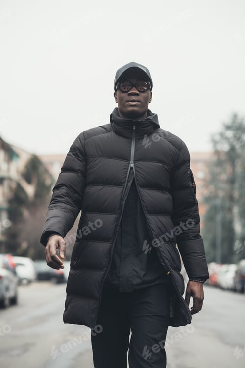 Preview: young bearded african man outdoors walking looking camera