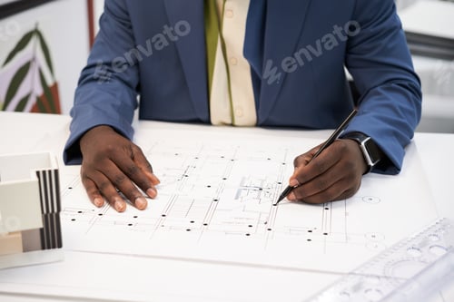 Preview: Architect drawing construction plan at desk