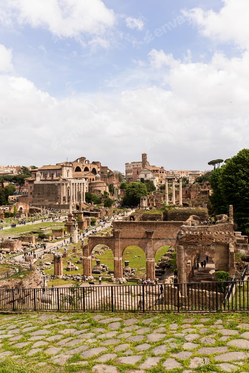 Preview: ROME, ITALY - JUNE 28, 2019: tourists near ancient buildings at roman forum under blue sky