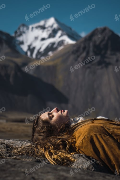 Preview: Dreaming woman on rock in nature