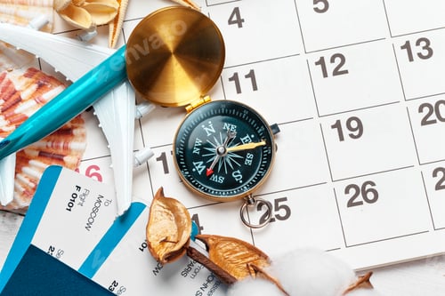 Preview: travel and vacation concept, compass on planner calendar