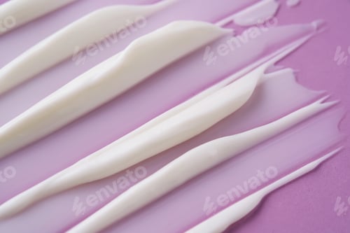 Preview: Swatch with white cream texture on a purple background.