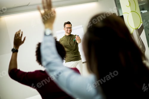 Preview: Students rising hands to answer the question during the workshop training