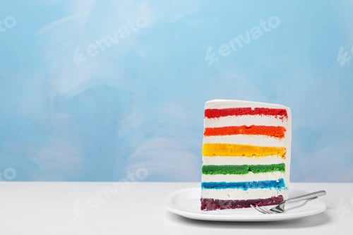 Preview: Plate with slice of delicious rainbow cake on table against color background
