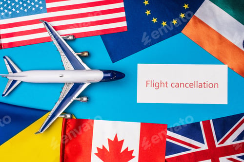 Preview: Top view of toy plane near card with flight cancellation lettering and flags of countries on blue