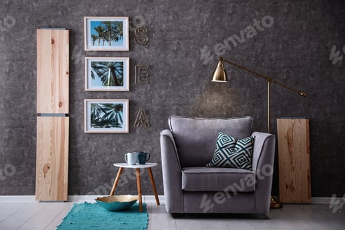 Preview: Interior of modern room with pictures on grey wall and cozy armchair