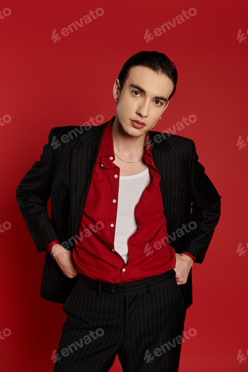 Preview: A Dash of Red: Elegant Man in Pinstripes Poses Against Vibrant Background
