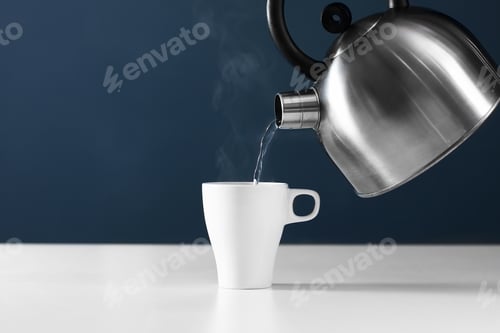 Preview: retro kettle pouring water into a cup on a white background with smoke on wood table
