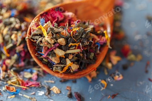 Preview: Handful of natural tea on a wodden surface