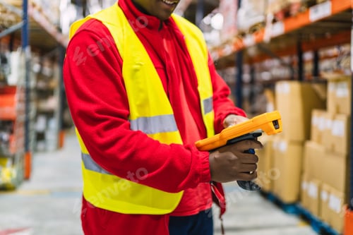 Preview: Warehouse worker scanning packages with handheld device