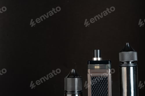 Preview: Vape and vape liquid bottles against black background